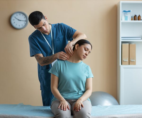 doctor-helping-patient-rehabilitation